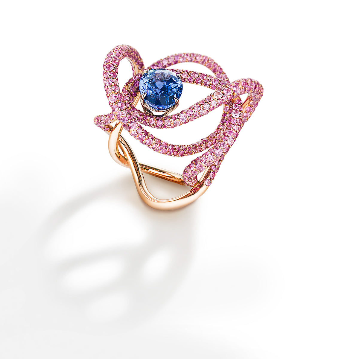 Ring with natural oval blue sapphire surrounded by rings of pink ...